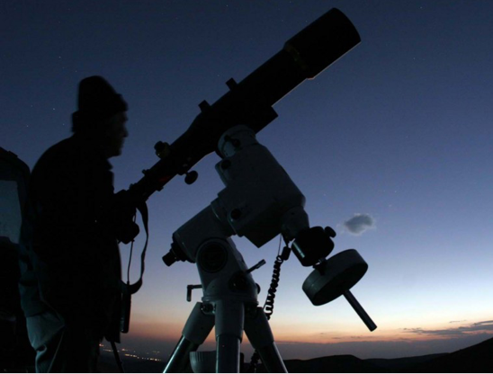 Image of an observer with a telescope