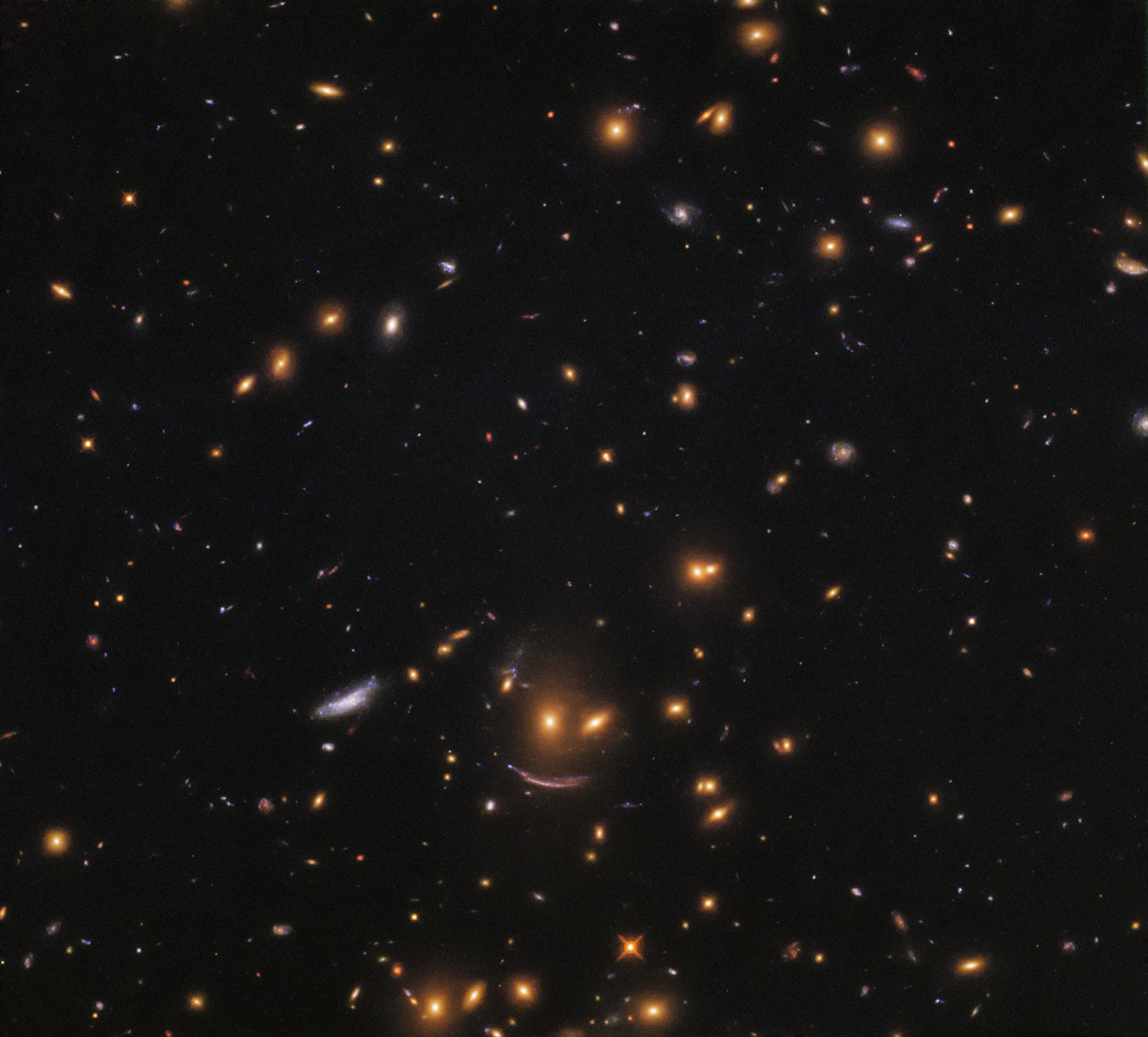 A smiley face is seen in a field of stars amid the black of space.
