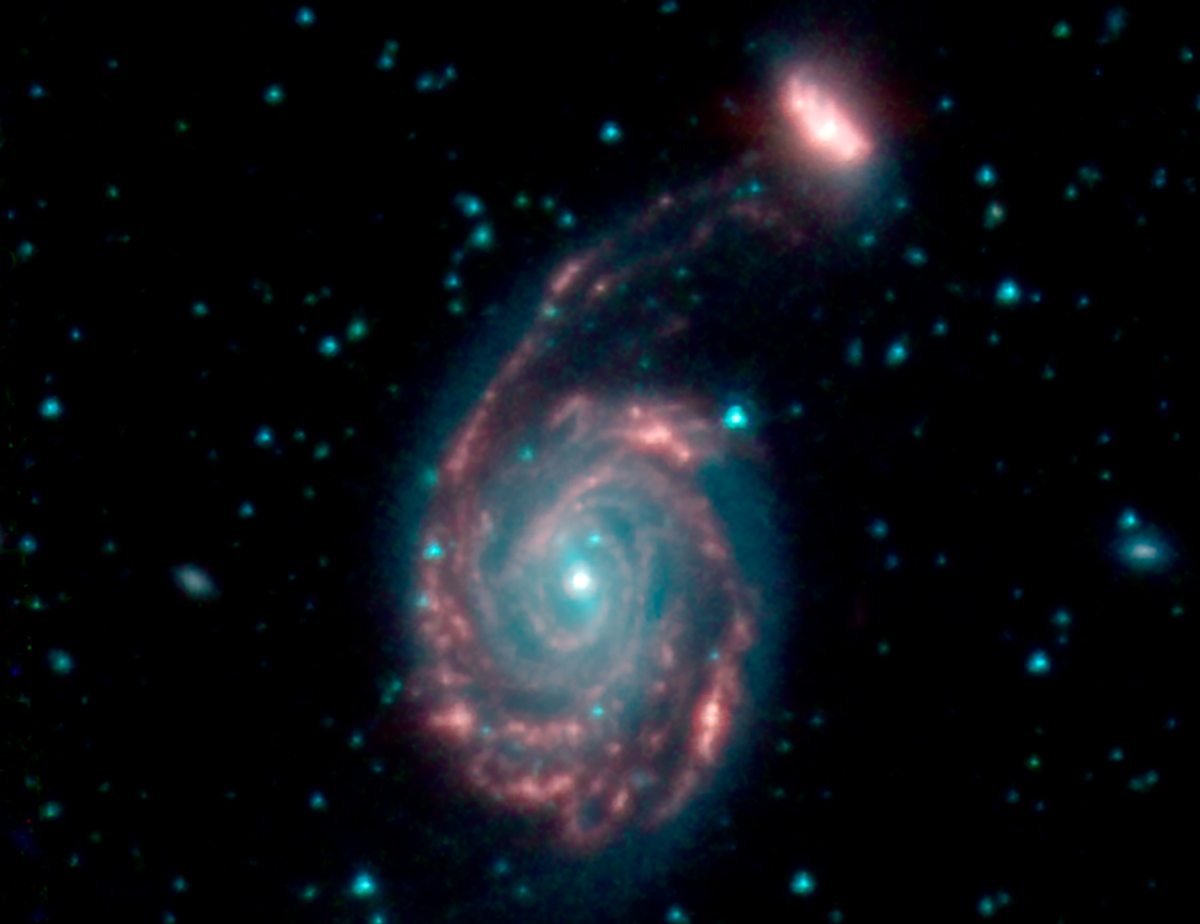 Spitzer space telescope images merging, swirling galaxies.