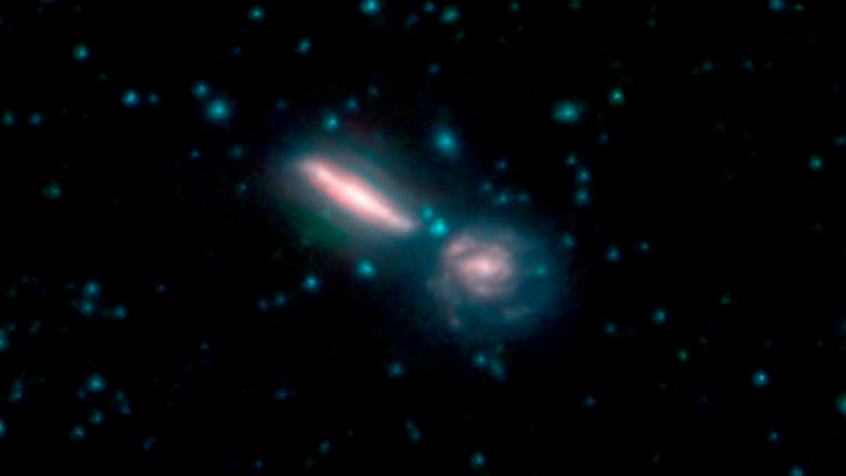 Smaller, bright merging galaxies seen in the blackness of space.