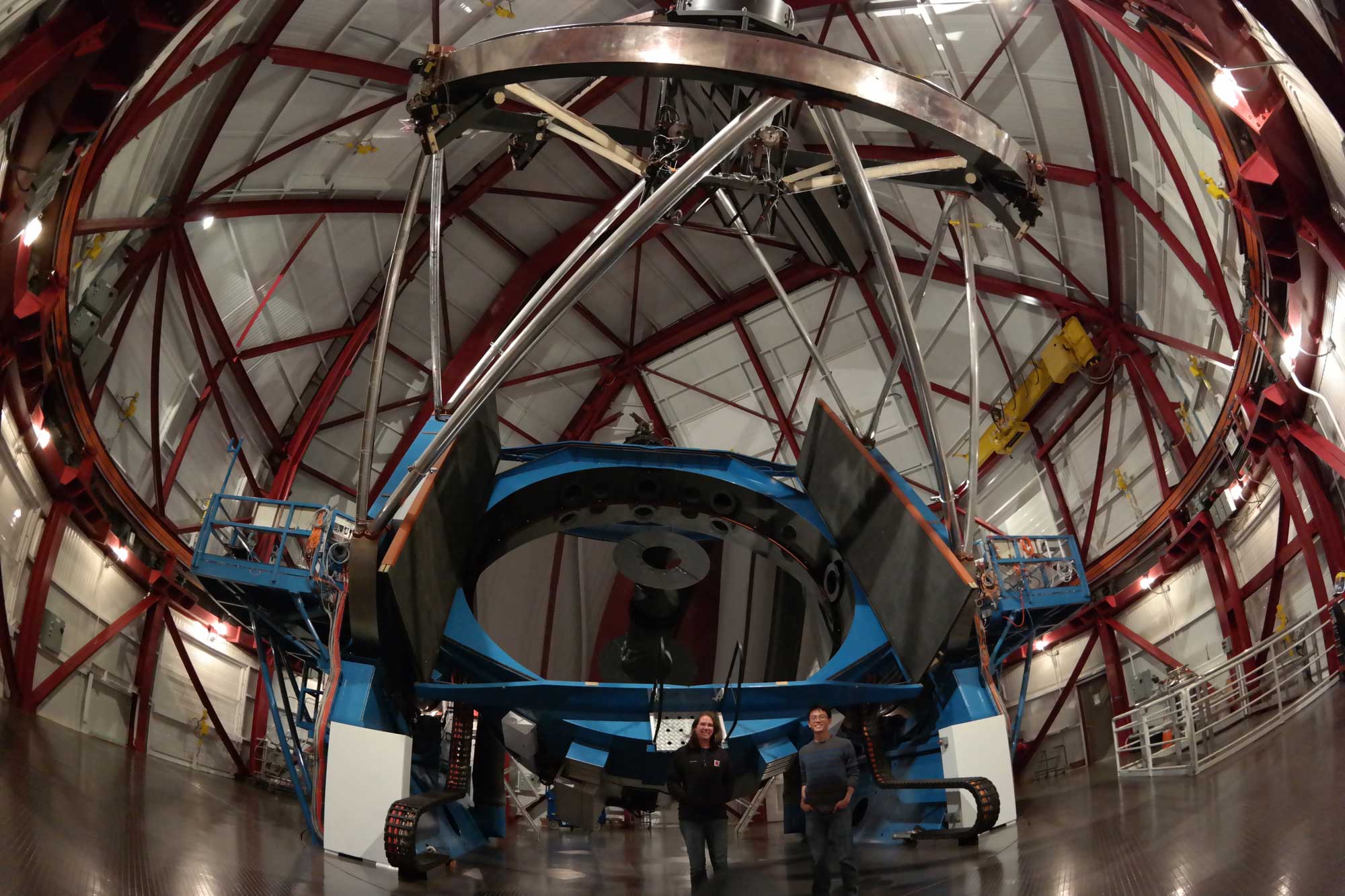 Two astronomers are seen inside the dome of the Magellan II telescope