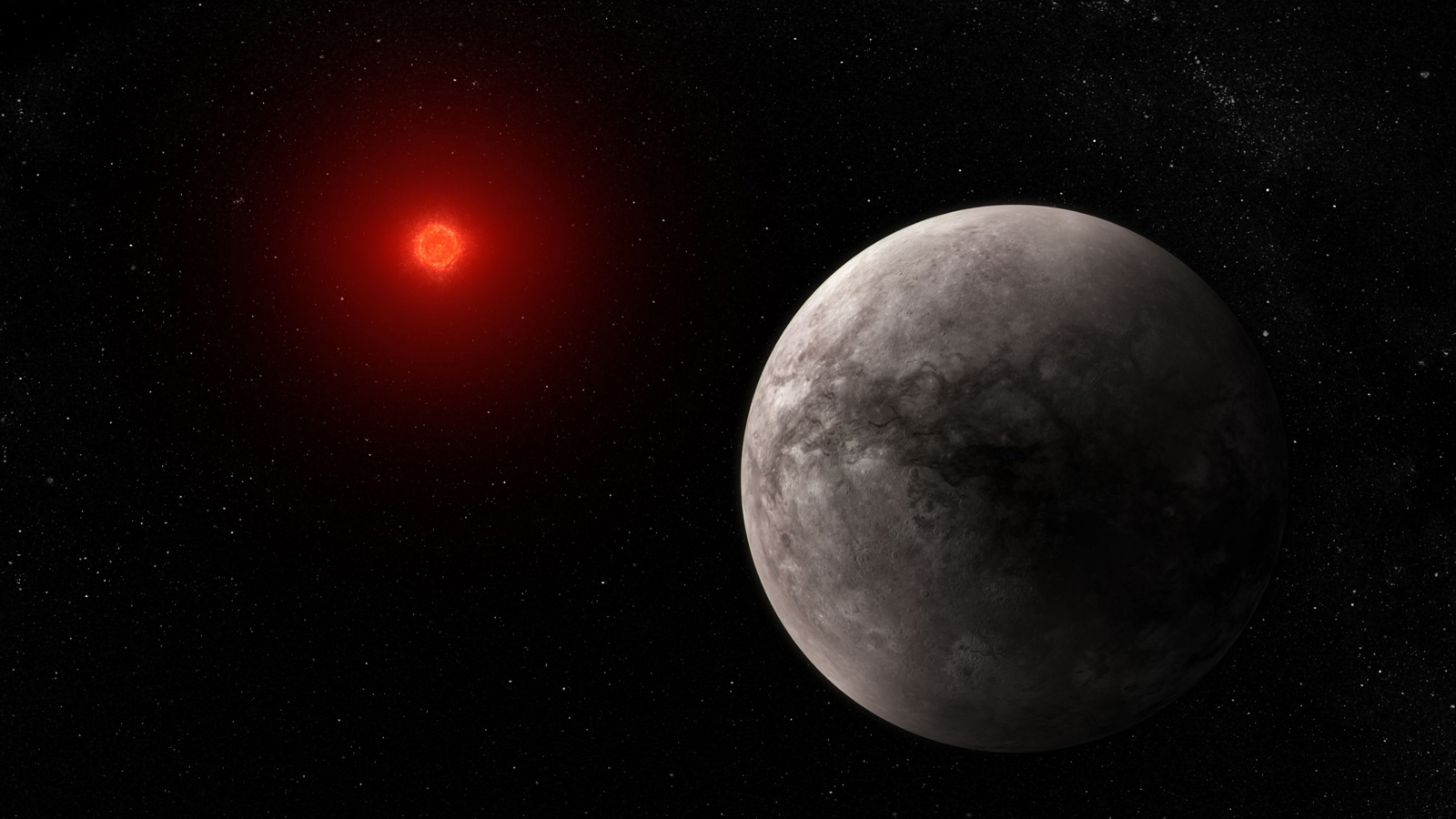 Illustration of a rocky planet and its red dwarf star on a black background. The planet is large, in the foreground on the lower right and the star is smaller, in the background at the upper left. The planet is gray. The star has a bright orange-red glow. This illustration shows what the hot rocky exoplanet TRAPPIST-1 b could look like based on this work. 