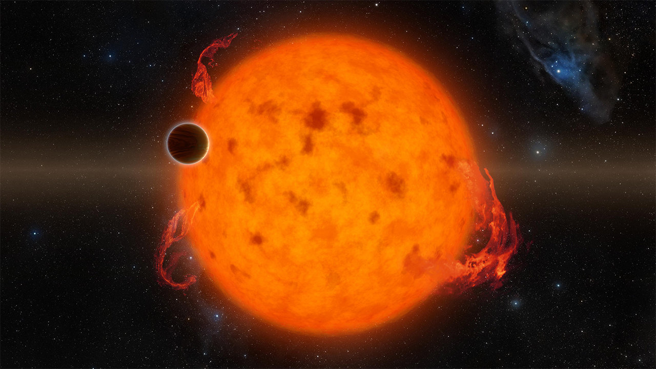 A small, dark planet transits in front of its fiery star.