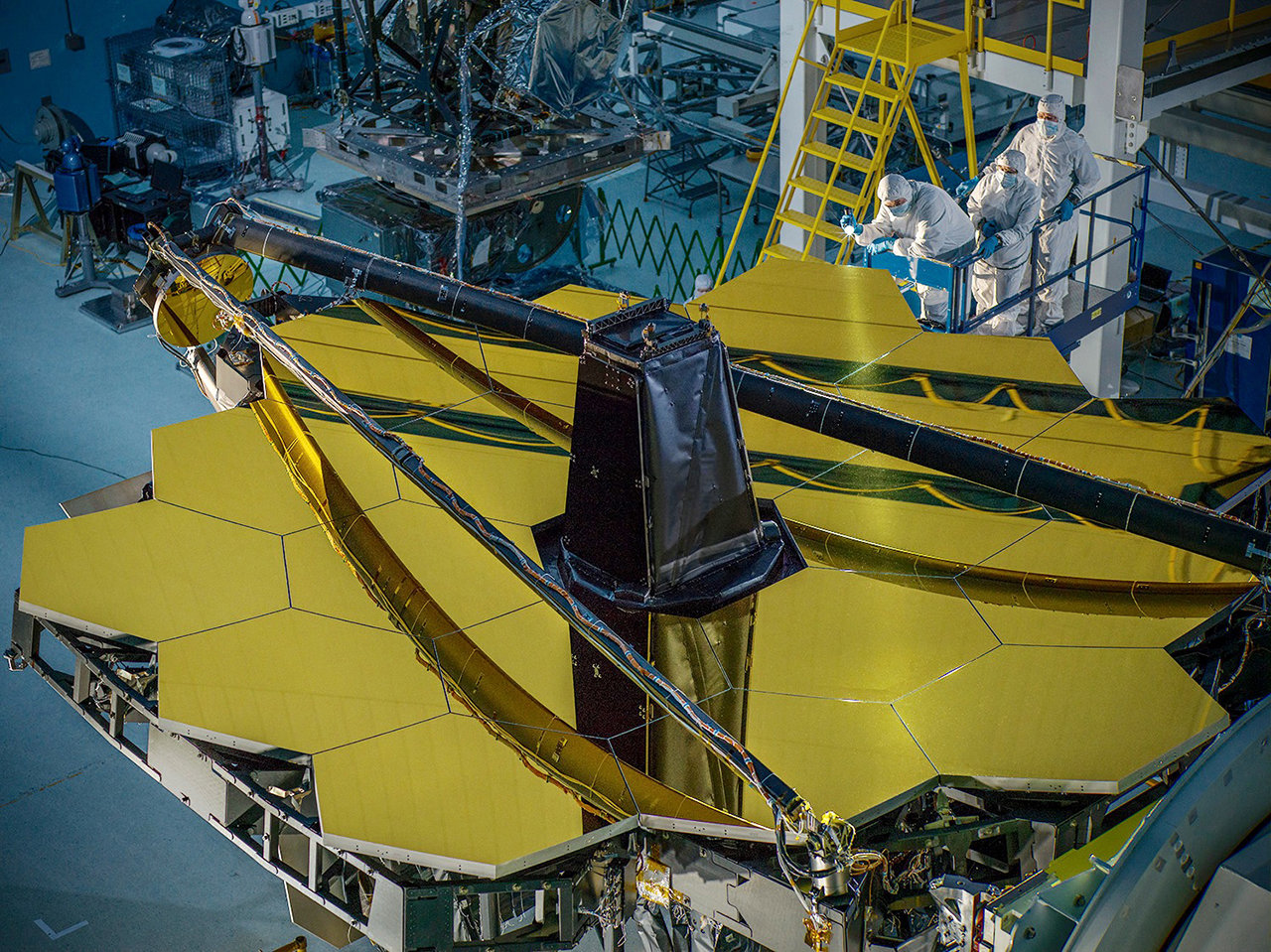 At a Goddard cleanroom, technicians unveil the James Webb Observatory’s segmented mirror.