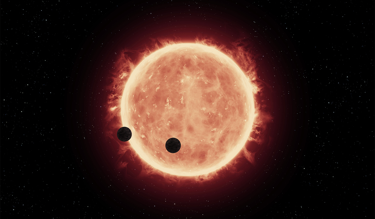 This illustration shows two Earth-sized worlds passing in front of their parent red dwarf star, which is much smaller and cooler than our sun. Credit: NASA/ESA/J. de Wit (MIT)/G. Bacon (STScI)