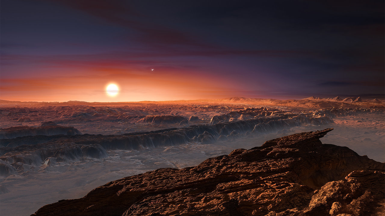 This artist’s impression shows a view of the surface of the planet Proxima b orbiting the red dwarf star Proxima Centauri, the closest star to the solar system. The double star Alpha Centauri AB also appears in the image. Proxima b is a little more massive than the Earth and orbits in the habitable zone around Proxima Centauri, where the temperature is suitable for liquid water to exist on its surface. Credit: ESO/M. Kornmesser