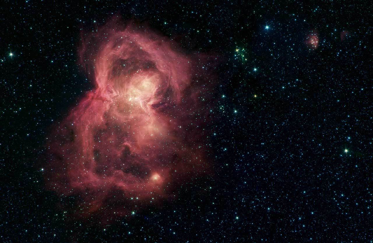 Officially known as W40, this red butterfly in space is a nebula, or a giant cloud of gas and dust. The "wings" of the butterfly are giant bubbles of gas being blown from the inside out by massive stars. 
Credit: NASA/JPL-Caltech